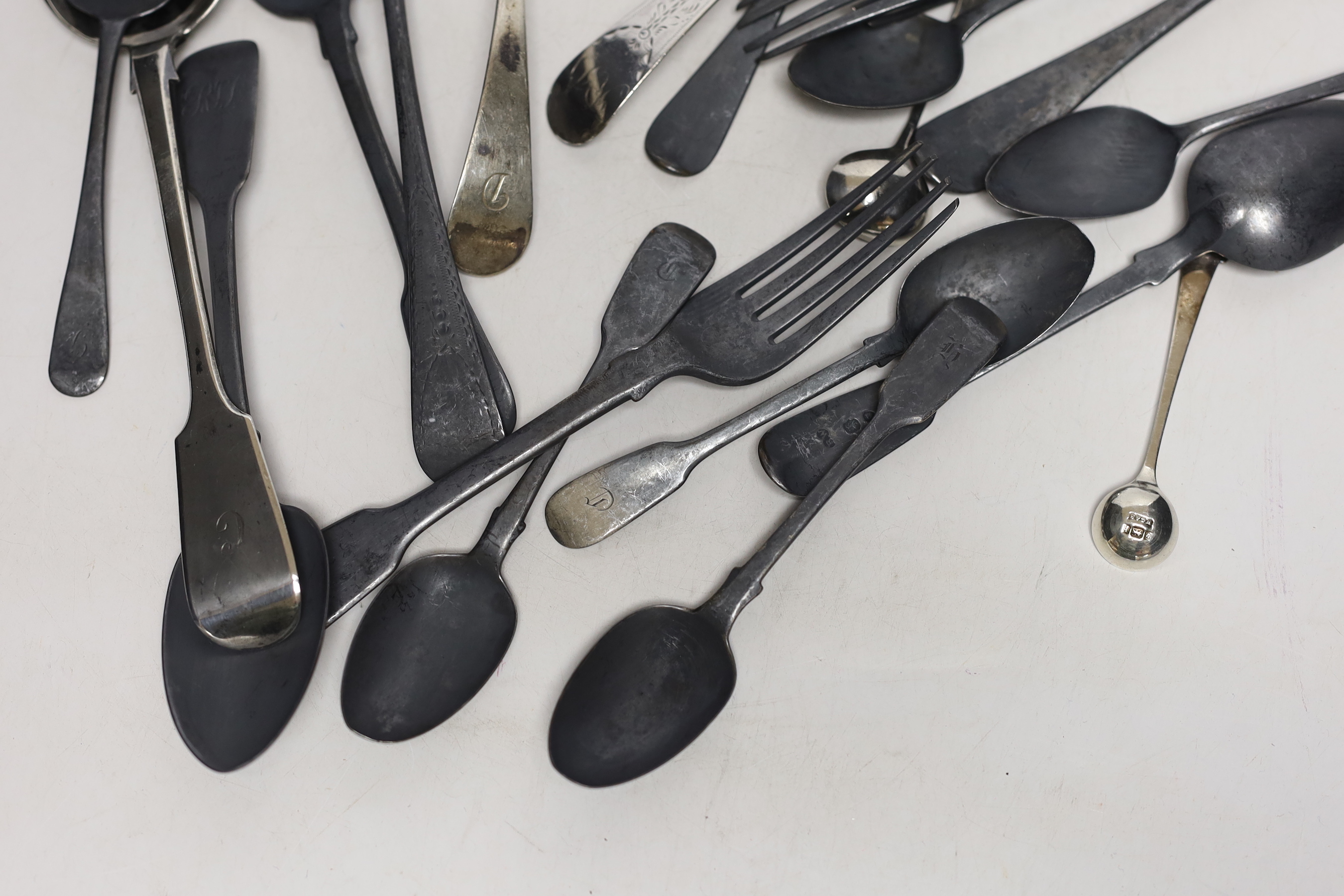 Twenty two assorted items of mainly 19th century flatware, various patterns, dates and makers, together with a small silver cream jug, 25.4oz.